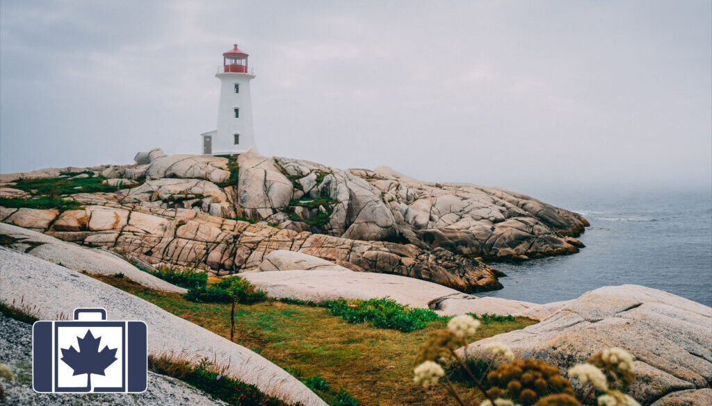 VisitorsInsurance.ca A photograph of a red capped lighthouse at Peggy's Cove surrounded by rugged coastal rocks under a gloomy sky.
