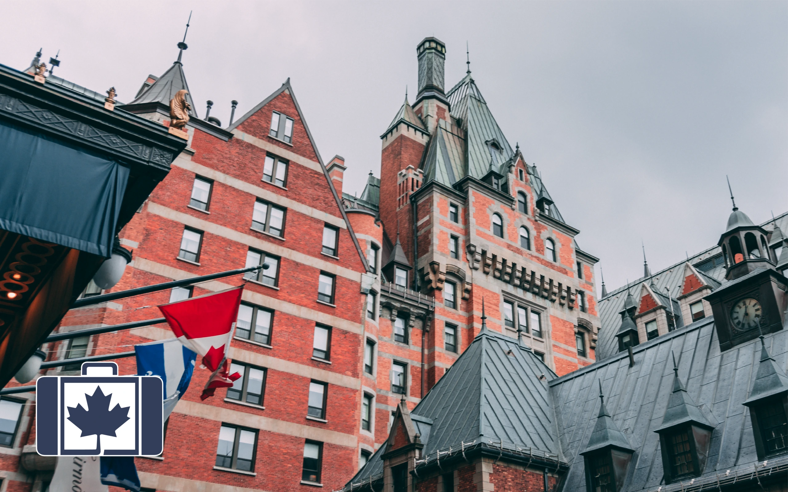 VisitorsInsurance.ca Low-angle view of the iconic Château Frontenac in Quebec City, displaying its historic red brick architecture and green copper turrets. Canadian and Quebec flags wave in the foreground.